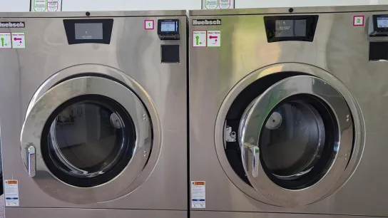 Why Our Machines Can Handle What Your Home Washer Can’t (And Why That Matters for Your Laundry)